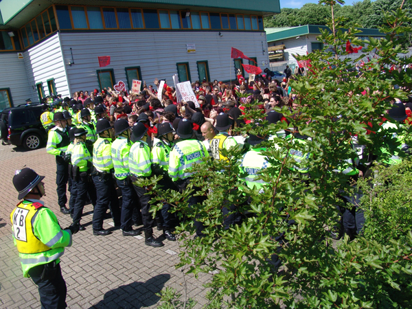 Demonstrators and police inside the EDO MBM car park at the Carnival Against the Arms Trade